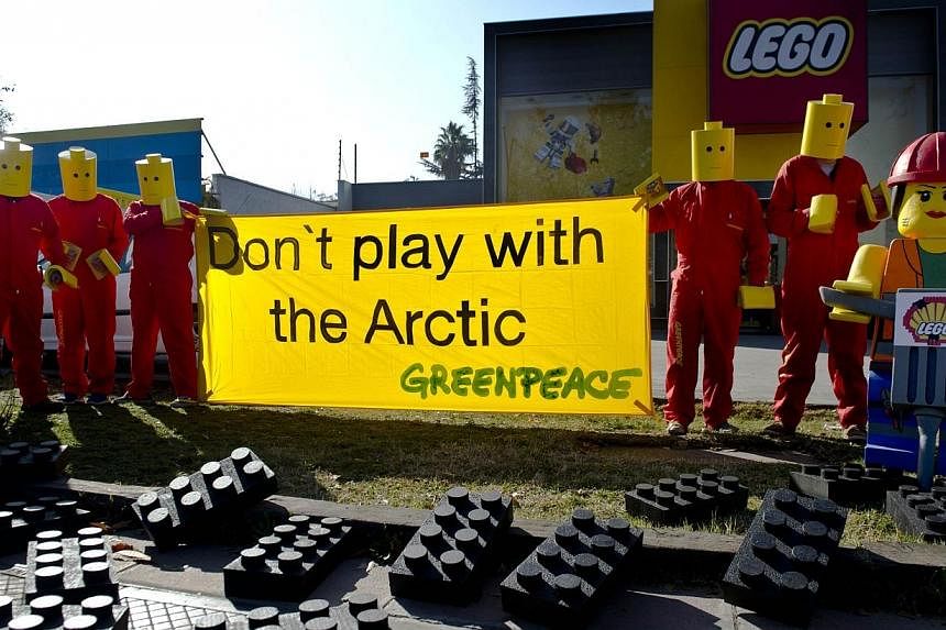Greenpeace activists hang a banner on July 24, 2014 in front LEGO headquarters in Santiago, Chile.&nbsp;The world's largest toymaker Lego said on Thursday it was ending a deal with oil giant Shell, bowing to pressure from a Greenpeace campaign linkin