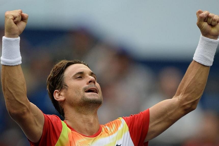 David Ferrer of Spain celebrates his victory against Andy Murray of Britain during their men's singles third round match at the Shanghai Masters 1000 tennis tournament held in the Qizhong Tennis Stadium in Shanghai on Oct 9, 2014. -- PHOTO: AFP