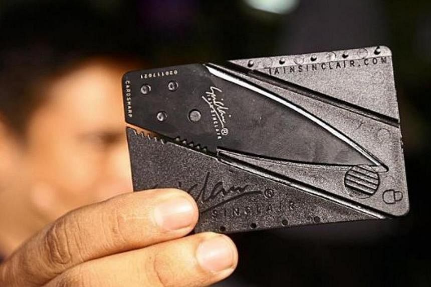 Not just a credit card: The innocuously disguised pocket blade camouflaged as a credit card can be slipped easily into the credit card compartment of a wallet and becomes a fatal knife within seconds. -- PHOTO: THE STAR/ASIA NEWS NETWORK