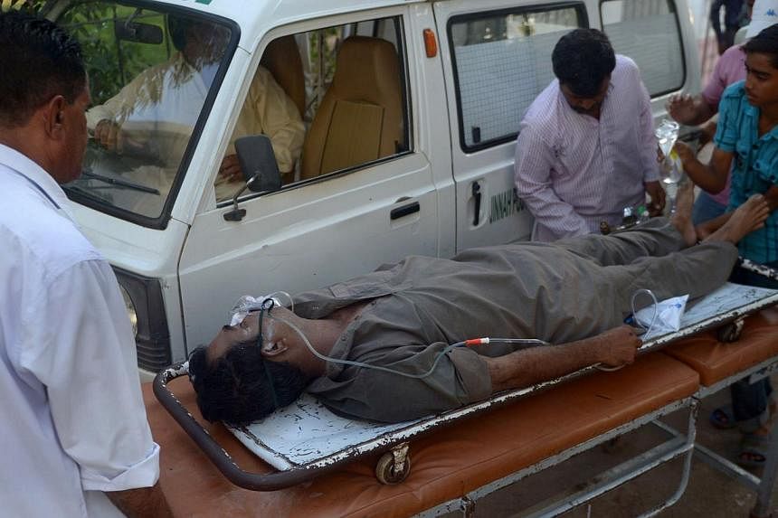 Pakistani paramedics shift a liquor victim to a hospital in Karachi on Oct 8, 2014. Twenty-one people in the southern Pakistani city of Karachi have died after drinking home-made liquor during Eid holidays, officials said, highlighting the dangers of