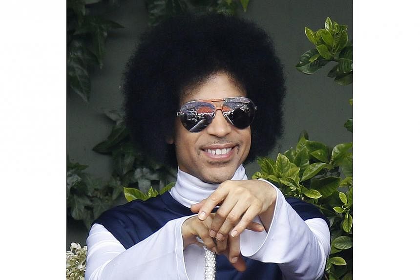 A file photo taken on June 2, 2014 shows US singer Prince attending the French Open tennis tournament. The rock and R&amp;B veteran scored two new debuts in the top 10 in the United States, as two country music artists Blake Shelton and Lady Antebell