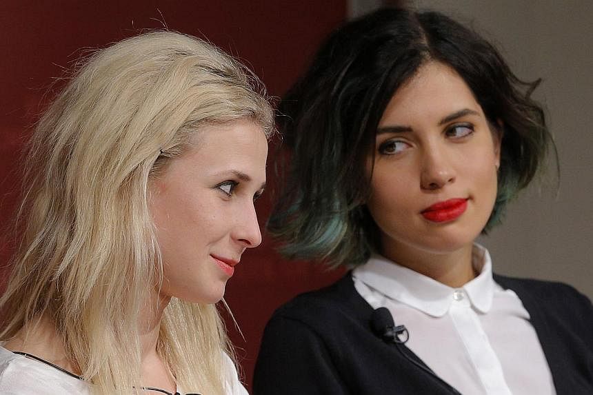 Maria Alyokhina (left) and Nadezhda Tolokonnikova, members of the punk protest band Pussy Riot, answer a question during a forum at the Kennedy School of Government at Harvard University in Cambridge, Massachusetts on Sept 15, 2014. Punk band Pussy R
