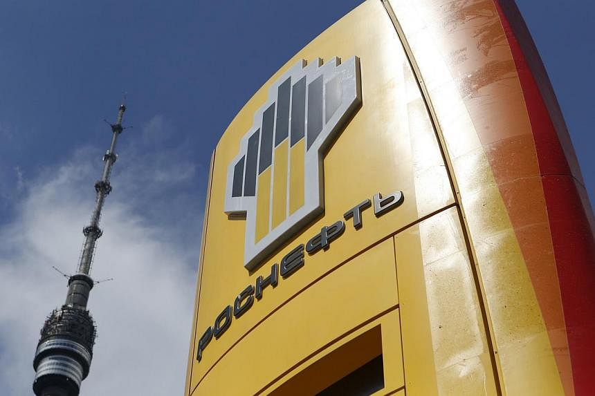 The logo of Russia's top crude producer Rosneft is seen on a price information board of a fuel station in Moscow on July 17, 2014. Rosneft has offered stakes in its two east Siberian oilfields to India's Oil and Natural Gas Corp, two Indian sources w