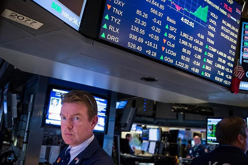 US stock markets cheered after the US central bank said in the minutes of its latest policy-seting meeting that it wants to keep interest rates close to zero for longer than expected, posting their biggest one-day gains in 2014. -- PHOTO: AFP