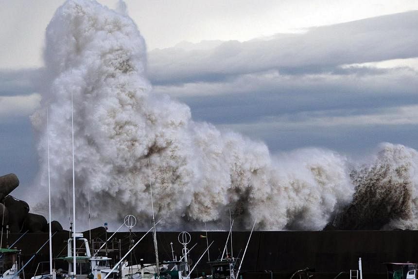 High waves from typhoon Phanfone batter a breakwater at a port at Kihou town in Mie prefecture, central Japan on Oct 6, 2014. -- PHOTO: AFP&nbsp;