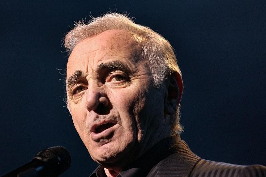 French-Armenian singer Charles Aznavour performing in Paris on his 80th birthday tour on April 16, 2004.&nbsp;Legendary French-Armenian singer Charles Aznavour, 90, has been hospitalised for an infection and has postponed a concert due to be held lat
