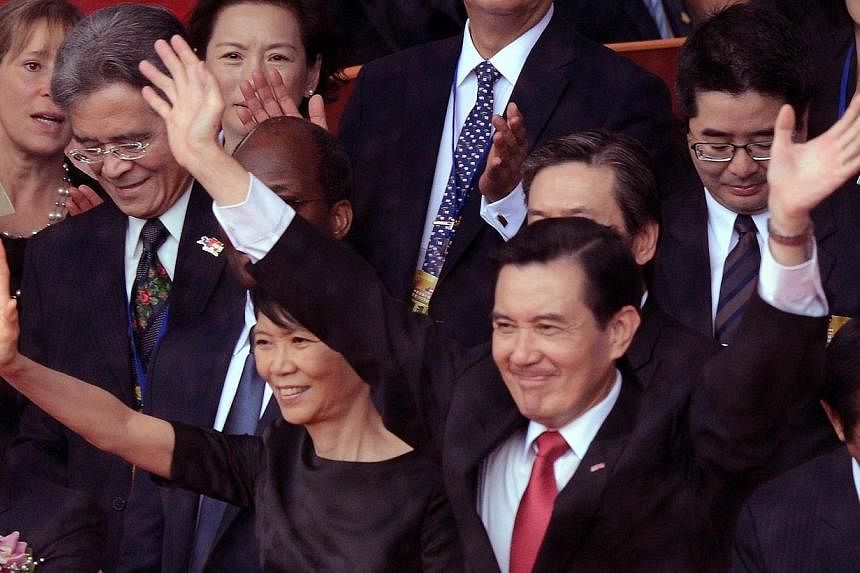 Taiwan President Ma Ying-jeou (centre, right) and his wife Chow Mei-ching wave during the national day anniversary in front of the Presidential Palace in Taipei on Oct 10, 2014. Mr Ma on Friday called on Beijing to "let some people go democratic firs