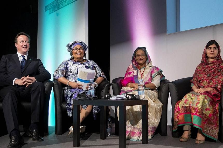 British Prime Minister David Cameron (left) sits with Chantal Compaore (second left), the First Lady of Burkina Faso, Sheikh Hasina Wajed (second right), the Prime Minister of Bangladesh, and Pakistani rights activist Malala Yousafzai (right) at the 
