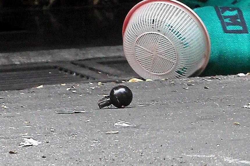 An intact grenade found at the scene. It is understood that there were two grenades and one did not explode. The grenade that went off left Malaysian Tiong Kwang Yie, 36, dead and 13 others injured. Police at the scene of the grenade blast in the pop