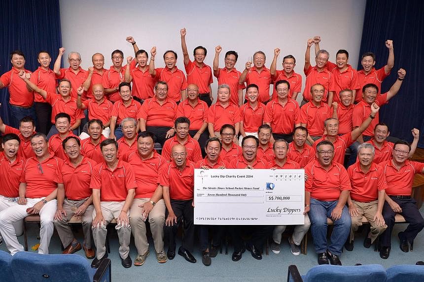 The Lucky Dippers, seen here with SPH's editor at large Han Fook Kwang (front row, sixth from left), aimed to raise $400,000 for The Straits Times School Pocket Money Fund and exceeded the target by $300,000. The group is into its fifth year of organ