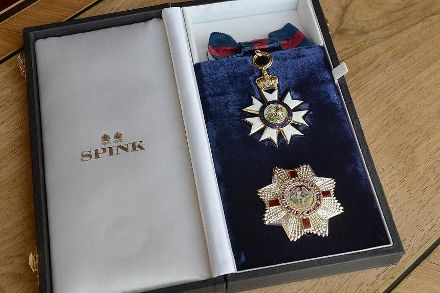 The Insignia of an Honorary Dame Grand Cross of the Most Distinguished Order of St Michael and St George presented to US actress Angelina Jolie by Britain's Queen Elizabeth II is pictured in central London, England on Oct 10, 2014. -- PHOTO: AFP
