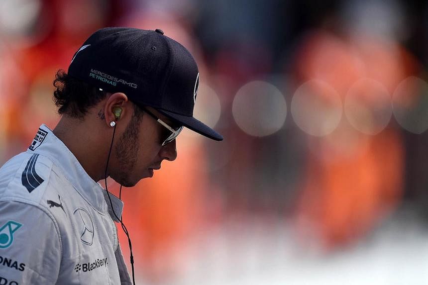 Mercedes-AMG's British driver Lewis Hamilton attends the first practice session of the inaugural Russian Formula One Grand Prix at the F1 Autodrome in Sochi on Oct 10, 2014. -- PHOTO: AFP