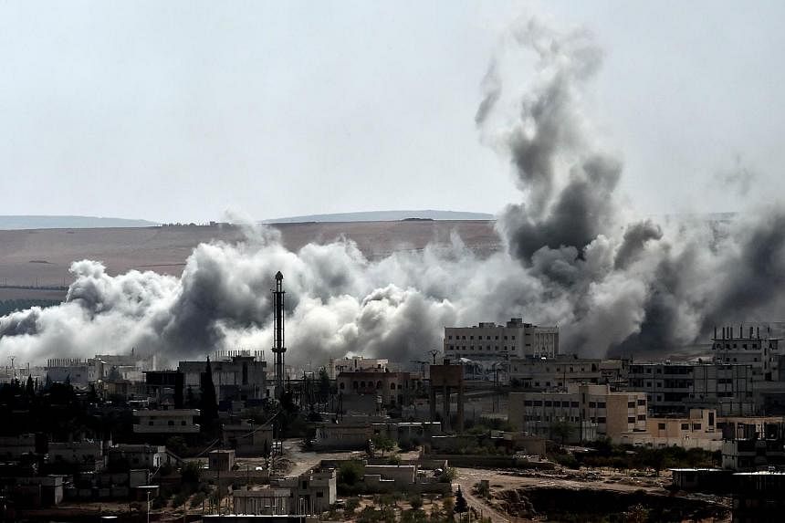 Smoke rises from an airstrike on the southwestern part of the Syrian town of Ain al-Arab, known as Kobane by the Kurds, as seen from the Turkish-Syrian border, in the southeastern Turkisk village of Mursitpinar, Sanliurfa province, on Oct 9, 2014.&nb