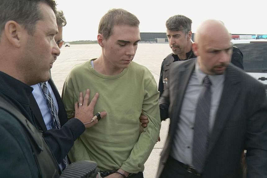 A file photo courtesy of Montreal police shows Luka Rocco Magnotta (centre) escorted by police upon arrival from Germany on June 18, 2012 in Quebec, Canada.&nbsp;Canadian Luka Magnotta, 32, has admitted to killing and dismembering Chinese student Jun