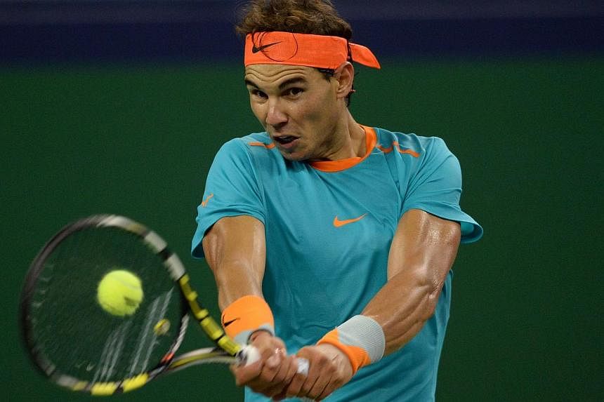 Rafael Nadal of Spain hits a return against Feliciano Lopez of Spain during their men's singles second round match at the Shanghai Masters 1000 tennis tournament held in the Qizhong Tennis Stadium in Shanghai on Oct 8, 2014. The world No. 2 returned 