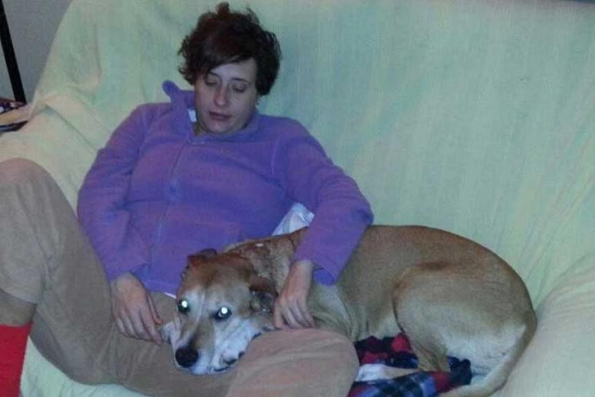 Teresa Romero Ramos is pictured with her dog Excalibur in this undated handout photo provided on Oct 8, 2014. The&nbsp;Spanish nurse, who is the first person known to have been infected with Ebola outside Africa, is at "serious risk" of dying after h