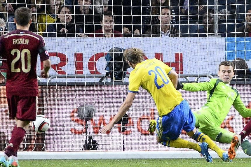 Sweden's forward Ola Toivonen scores past Russia's goalkeeper Igor Akinfeev on Oct 9, 2014 at Friends Arena in Solna, near Stockholm during the Euro 2016 qualifying football match between Sweden and Russia. -- PHOTO: AFP