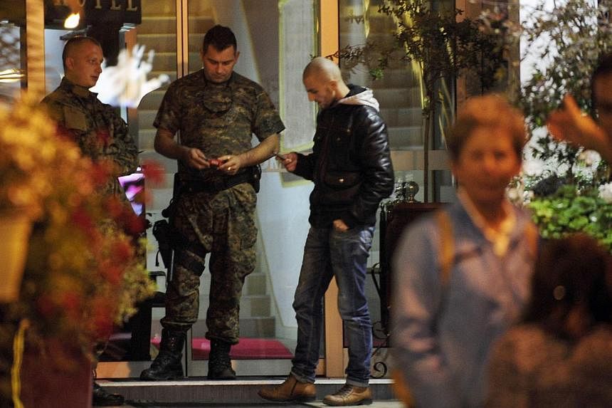 Police guard the entrance of a quarantined hotel in Skopje on October 9 where a British man showing symptoms of the Ebola virus died in Macedonia on Thursday. -- PHOTO: REUTERS&nbsp;