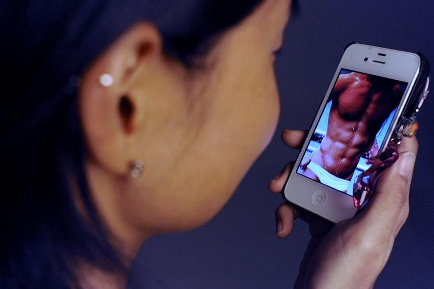A girl checks out a sexy image on a cellphone in this file photo.&nbsp;"Sexting," or sending sexually explicit images by phone, remains prevalent among US teenagers despite the well-known risks and consequences, according to a new study. -- ST FILE P