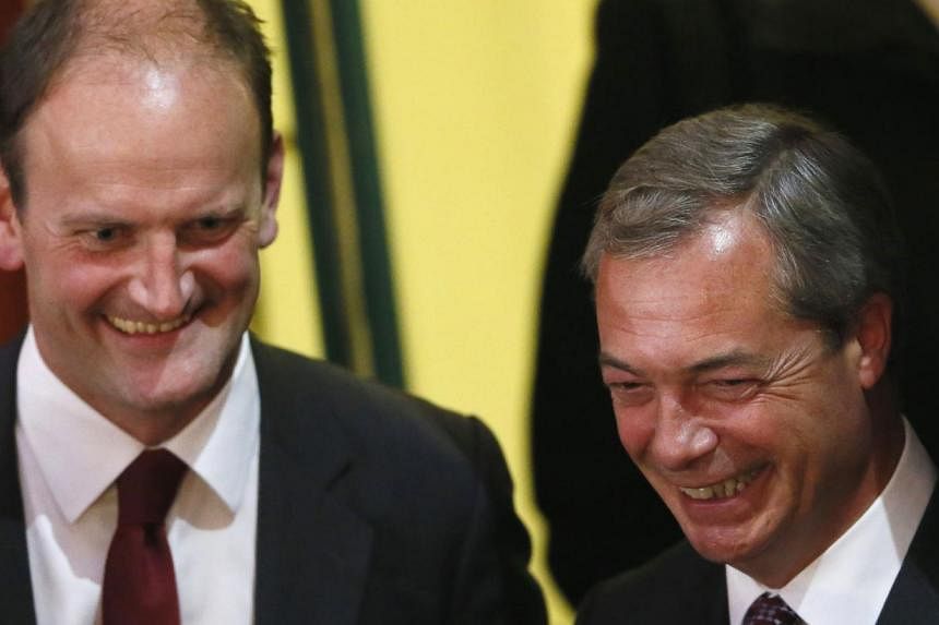 United Kingdom Independence Party (UKIP) candidate Douglas Carswell (L) and UKIP leader Nigel Farage at the Town Hall in Clacton-on-Sea in eastern England on Oct 10. Britain's anti-EU UKIP won its first elected seat in parliament on Friday.
