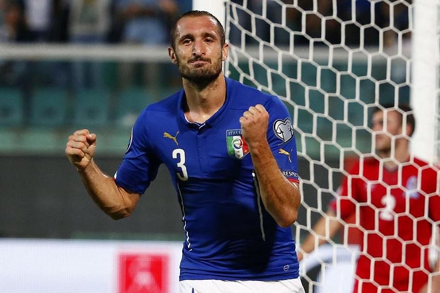 Italy's Giorgio Chiellini celebrates after scoring during the Uefa Euro 2016 group H qualifying football match between Italy and Azerbaijan at the Renzo Barbera Stadium in Palermo on Oct 10, 2014. -- PHOTO: AFP