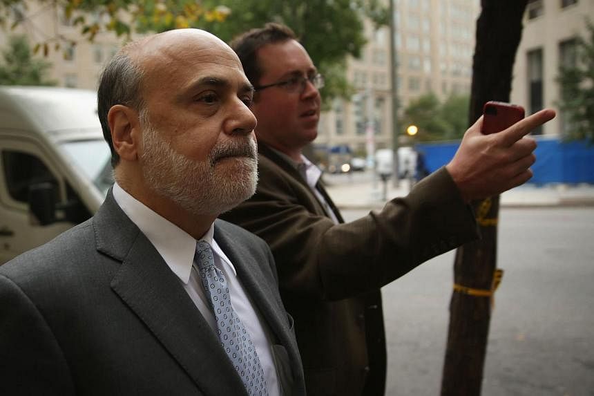 Former Chairman of the Federal Reserve Ben Bernanke (left) arrives at US Court of Federal Claims to testify at the AIG trial&nbsp;on&nbsp;Oct 10, 2014 in Washington, DC. -- PHOTO: AFP