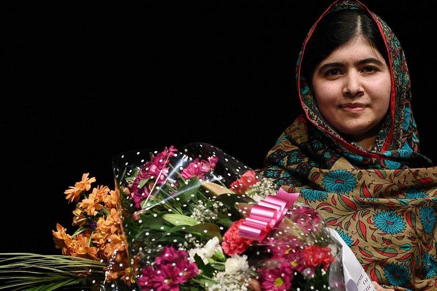 Pakistani rights activist Malala Yousafzai poses for a photograph after addressing the media in Birmingham, central England on Oct 10, 2014. -- PHOTO: AFP