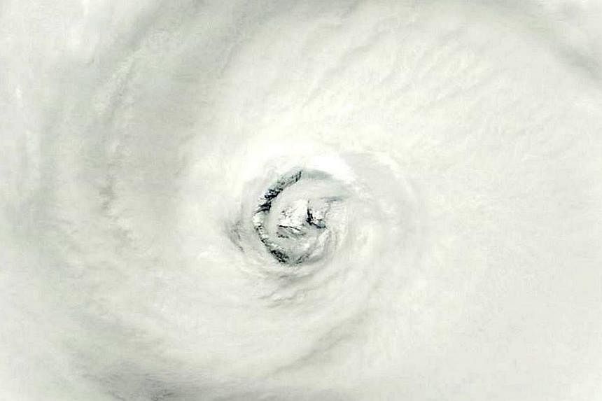 This October 10, 2014, satellite image from NASA shows the eye of Super Typhoon Vongfong in the Philippine Sea. The Joint Typhoon Warning Center predicts landfall around October 12, 2014 at 23:00 UTC near Sasebo, Japan. -- PHOTO: AFP