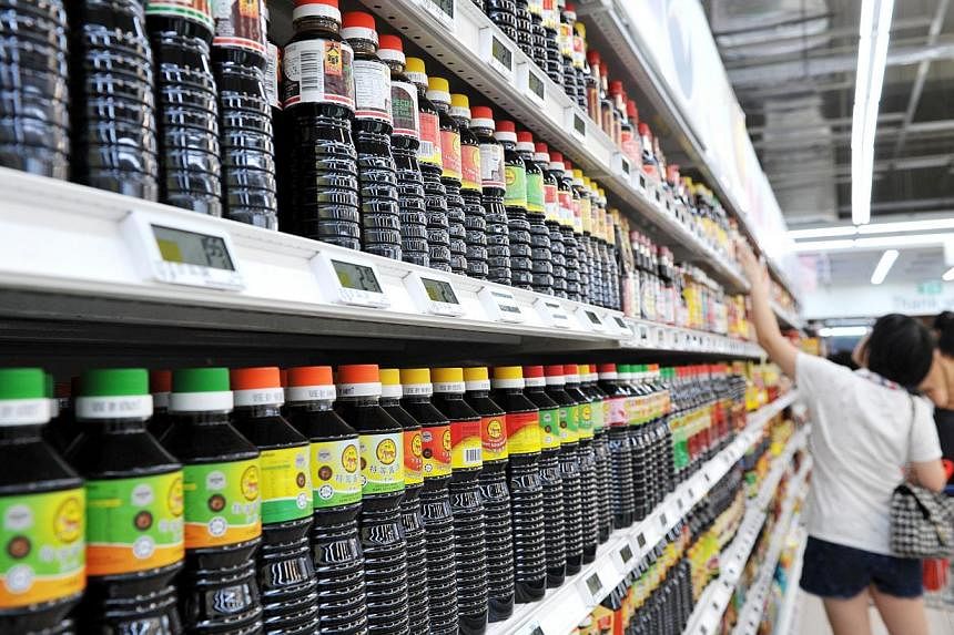 Soya sauce is one of the items which consumers here are buying smaller portions of, along with other essentials such as rice and cooking oil. The smaller bottles of soya sauce (upper shelf) are proving more popular than the bigger bottles (lower shel