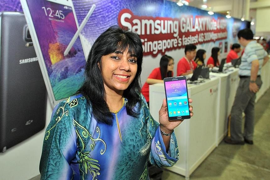 Madam Zahra Aspar started queueing from 7am for Samsung's Galaxy Note 4 at the launch event at Marina Bay Sands yesterday. She got the phone for the stylus pen and its wide selfie feature.