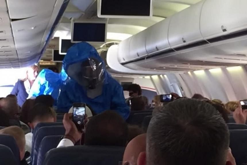 A screenshot from a video on YouTube that has been viewed more than two million times of a hazmat team boarding&nbsp;US Airways Flight 845 from Philadelphia to the Dominican Republic tourist resort of Punta Cana on Wednesday after a passenger reporte