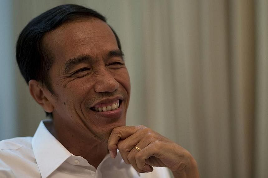 Indonesia's&nbsp;President-elect Joko Widodo, seen here (above) in July, on Friday sought to reassure Indonesians and foreign investors that his relationship with parliament over the next five years will be one of cooperation, not antagonism. -- PHOT