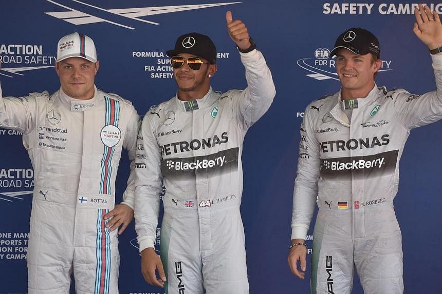 (From left to right) Williams' Finnish driver Valtteri Bottas, Mercedes' British driver Lewis Hamilton and Mercedes' German driver Nico Rosberg wave after taking top 3 positions in the qualifying session of the inaugural Russian Grand Prix at the Soc