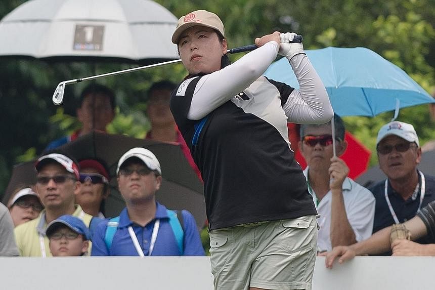 Feng Shanshan of China tees off on the 17th hole during the final round of the Sime Darby LPGA Malaysia 2014 tournament at the Kuala Lumpur Golf and Country Club in Kuala Lumpur on Oct 12, 2014.&nbsp;Feng ripped four birdies and an eagle through the 