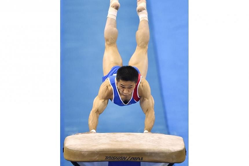 Ri Se Gwang of North Korea performs during the men's vault final at the gymnastics world championships in Nanning on Oct 12, 2014.&nbsp;The veteran Ri won his first global title on Sunday in the men's vault, as South Korea's defending champion and Ol
