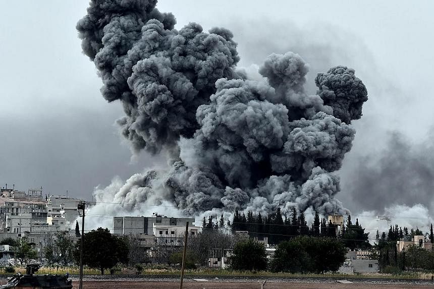 Smoke rises after a strike on the Syrian town of Ain al-Arab, known as Kobane by the Kurds, as seen from the Turkish-Syrian border, in the southeastern village of Mursitpinar, Sanliurfa province, on Oct 12, 2014.&nbsp;Islamic State in Iraq and Syria 