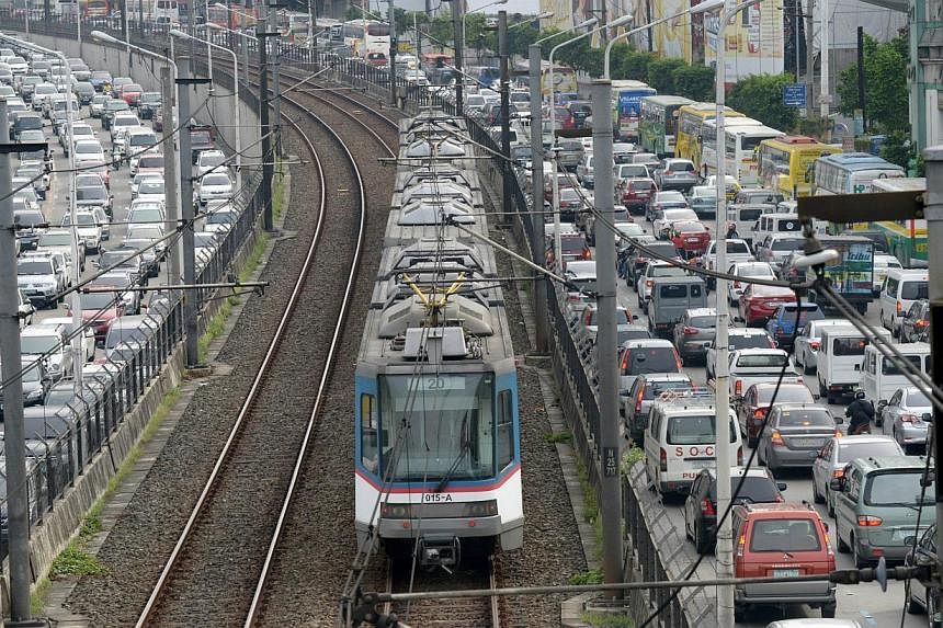 A major thoroughfare in the Manila is clogged with traffic on Sept 8, 2014, as an overhead trains whiz by in the centre lane. Manila already loses 2.4 billion pesos (S$68.4 million) in potential income daily due to traffic jams, according to a study 
