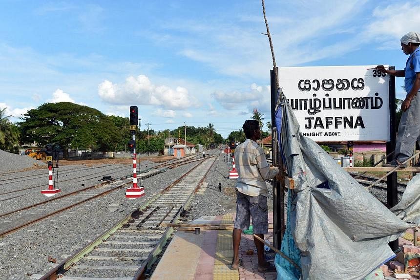 Sri Lankan construction labourers working at the Jaffna railway station on Oct 1, 2014. A railway in Sri Lanka that runs through minefields and snake-infested jungle is to reopen on Oct 13, 2014, nearly a quarter of a century after a bloody ethnic co