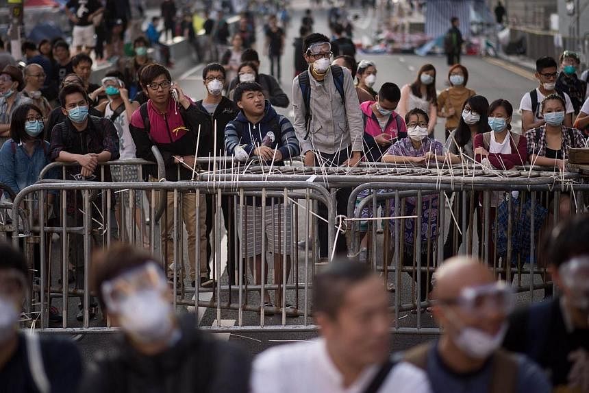 Pro-democracy protesters gather near barricades in the Admiralty district of Hong Kong on Oct 13, 2014.&nbsp;The pro-democracy demonstrators are winning unexpected support from pockets of the city's much-vilified mainland Chinese community, who are d