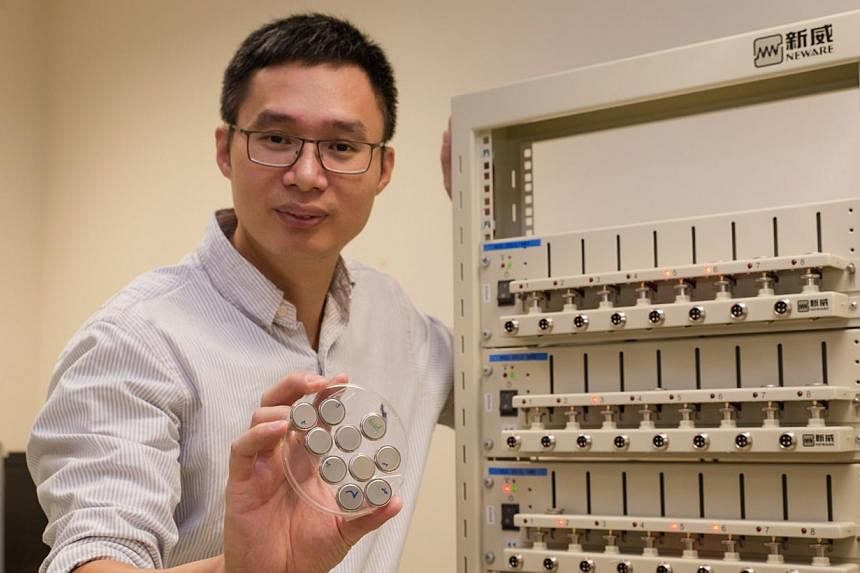 NTU Associate Professor Chen Xiaodong holding the ultra-fast rechargable batteries in his right hand, with the battery test station to his left.&nbsp;Nanyang Technological University (NTU) scientists have developed a battery that can be charged up to
