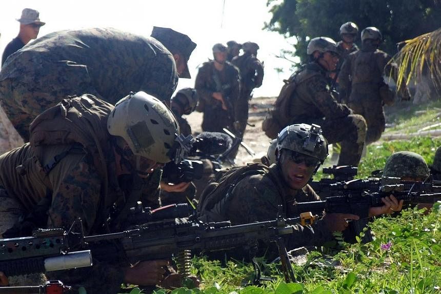 Philippine and US marines take their positions during the annual joint naval exercise dubbed "Phiblex" at an island near the south China sea in Puerto Princesa, Palawan island on Oct 2, 2014.&nbsp;Philippine authorities are investigating the possible