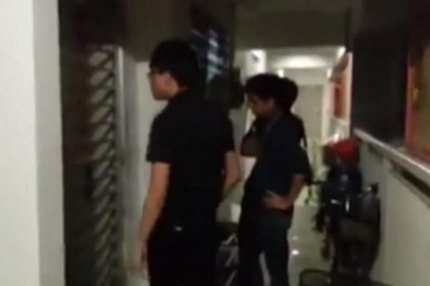 A screengrab from the video posted by&nbsp;socio-political website The Online Citizen, which shows&nbsp;three debt collectors knocking on an alleged debtor's Housing Board flat in Buangkok. -- PHOTO: YOUTUBE/THE ONLINE CITIZEN&nbsp;