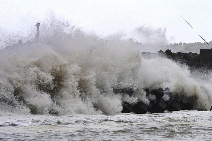 High waves batter a breakwater at a port of Kawaminami town in Miyazaki prefecture, Japan's southern island of Kyushu on Oct 13, 2014. -- PHOTO: AFP