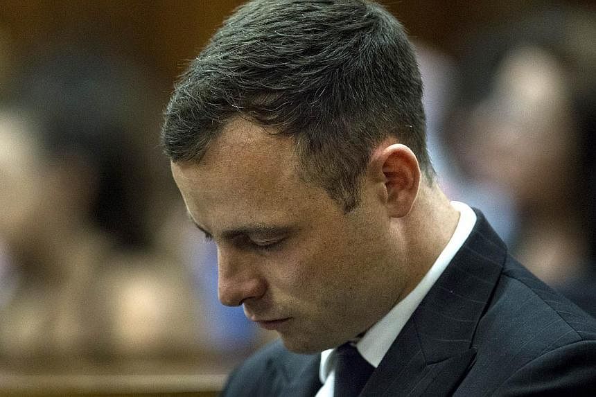 South African Paralympic athlete Oscar Pistorius looks down while his phycologist gives evidences during his sentencing hearing at the High Court in Pretoria, South Africa on Oct 13, 2014. -- PHOTO: AFP