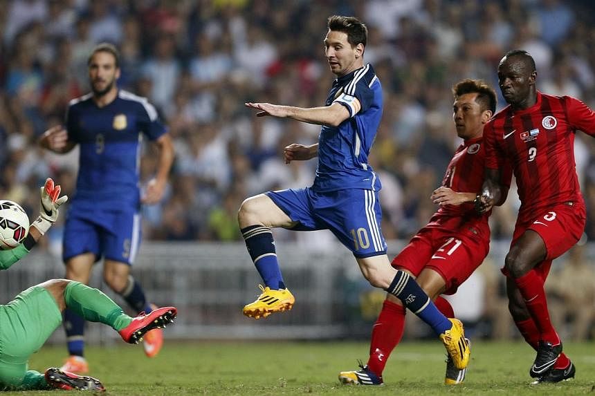 Argentina's Lionel Messi (centre) scores his first goal during their international friendly soccer match against Hong Kong, in Hong Kong on Oct 14, 2014. Argentina strolled to a 7-0 friendly win over Hong Kong on Tuesday, with superstar Messi and Nap