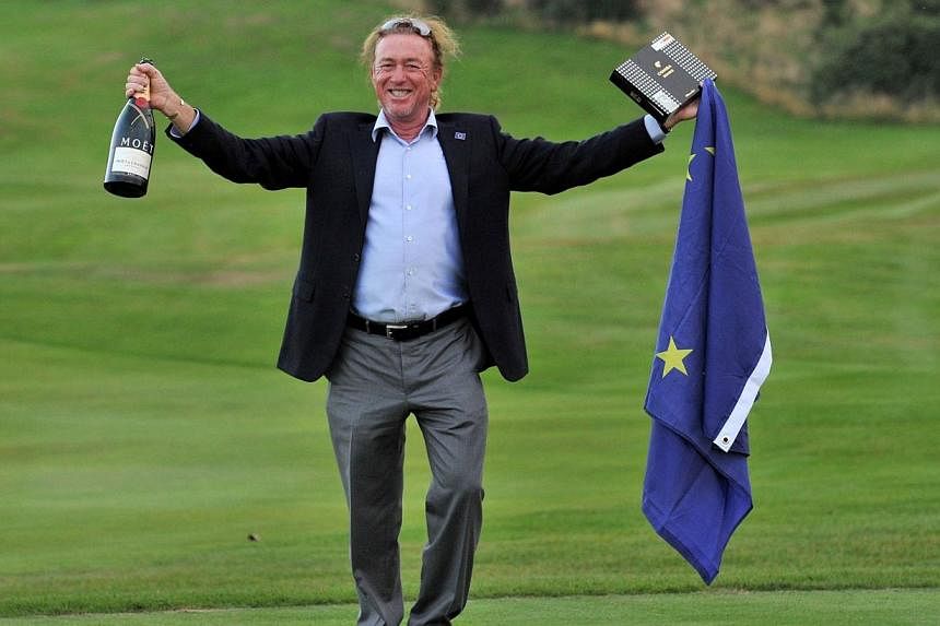 Vice-captain of Team Europe Miguel Angel Jimenez of Spain celebrates after Team Europe retained the Ryder Cup on the final day of the Ryder Cup golf tournament at the Gleneagles Hotel in Gleneagles, Scotland, on Sept 28, 2014. -- PHOTO: AFP