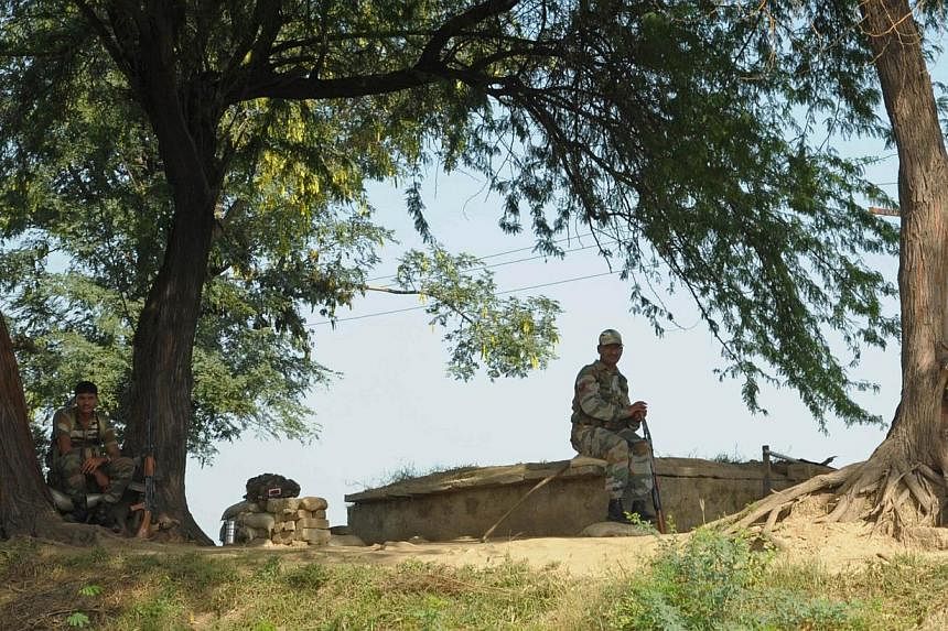 Indian Border Security Force soldiers keep watch following cross-border firing between Pakistan and Indian troops at Ramgarh, about 35 kms from Jammu, on Oct 11, 2014.&nbsp;Senior Pakistani and Indian military officials spoke Tuesday by hotline after