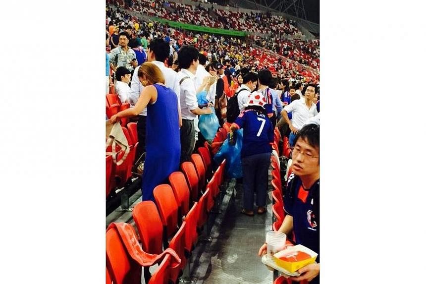A fan at the Sports Hub during the Brazil-Japan friendly match tweeted this picture of Japanese fans cleaning up. -- PHOTO: TWITTER/BK