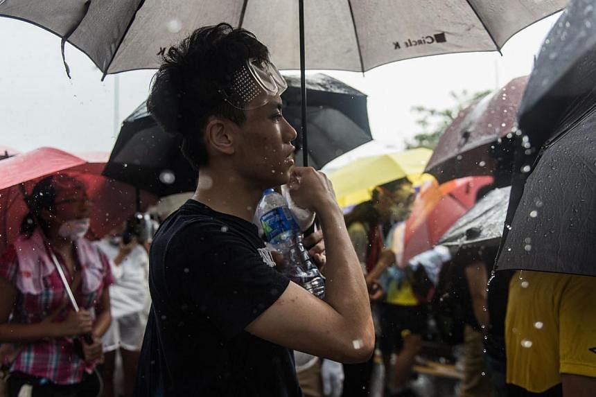 Hong Kong protesters singing Under A Vast Sky in the rain. -- PHOTO: AGENCE FRANCE-PRESSE