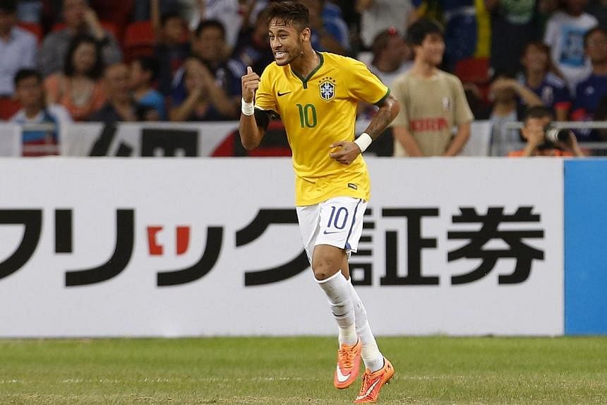Brazil's Neymar celebrates after scoring against Japan during their friendly soccer match at the national stadium in Singapore on Oct 14, 2014. -- PHOTO: REUTERS
